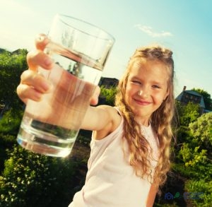 A Girl Holding a Glass of Water