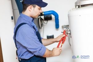 Plumber Adjusting a Water Heater