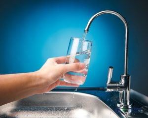 A Person Getting a Cup of Tap Water