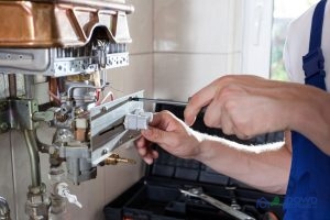 Plumber Performing a Water Heater Inspection